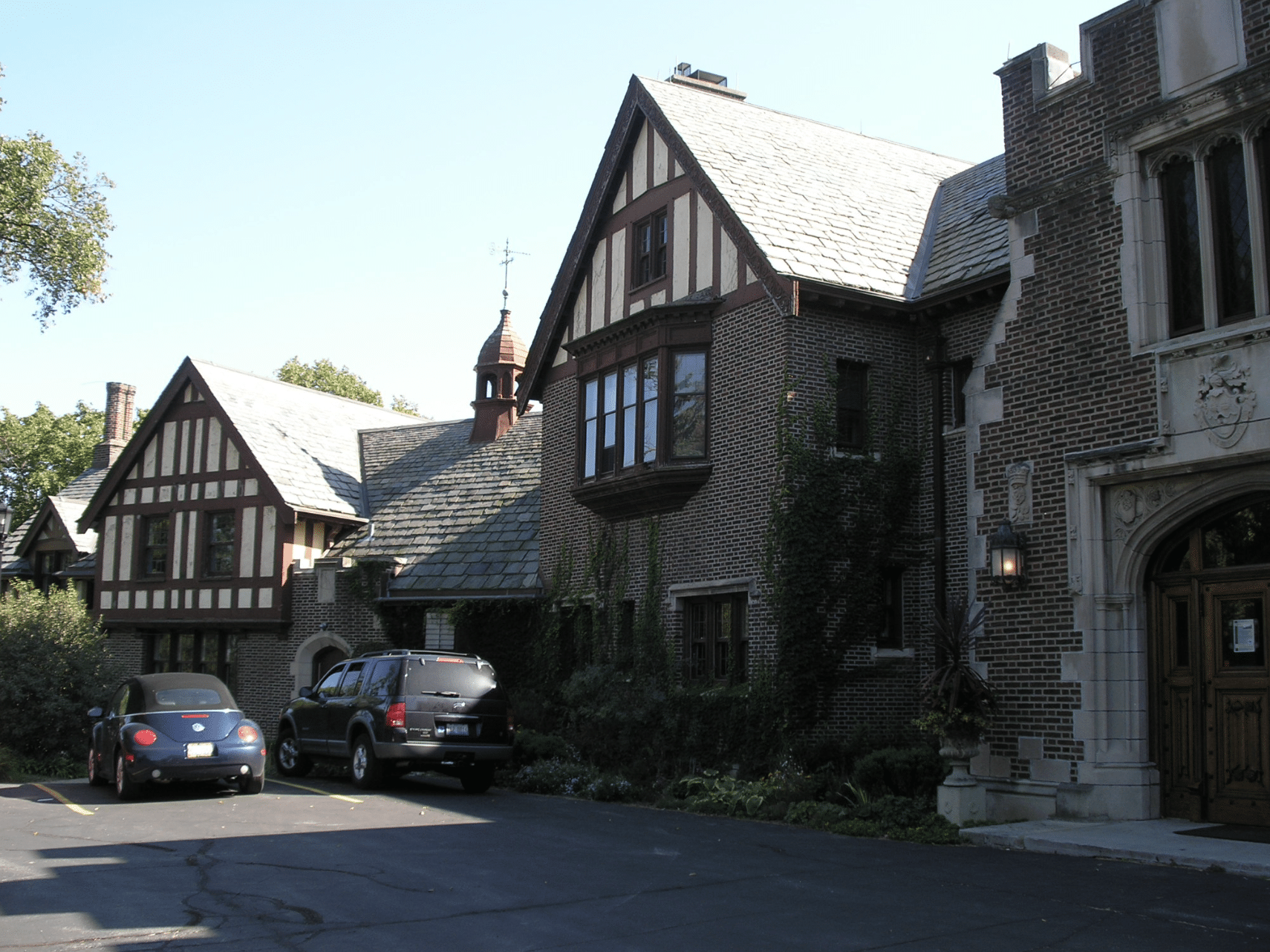 Historic Oak Brook buildings with Tudor-style architecture and parked vehicles, representing the local community where Taxx Resolution offers tax services.